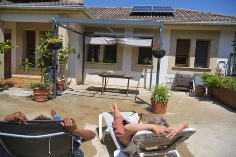 Relaxing in the backyard under the sun with a small dog Stock Photos