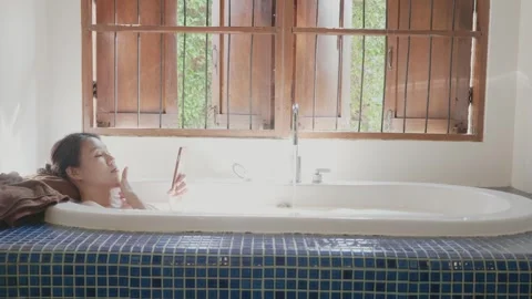 Relaxing Bath Experience in a Cozy Bathroom Setting Video stock 333582248