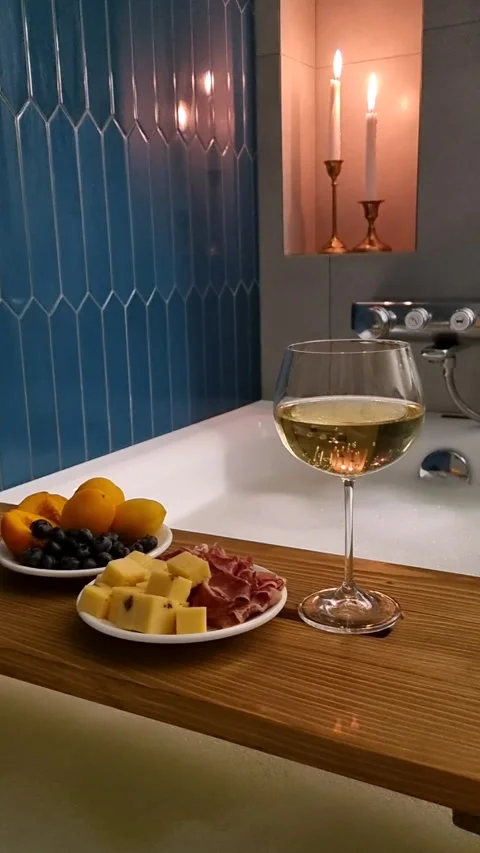 Relaxing bath with glass of white wine and snacks. Stock Footage 339910285