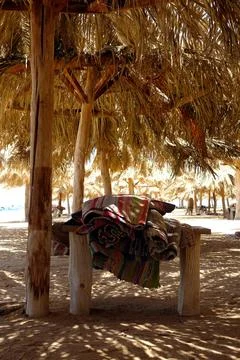 Relaxing by the Beach Under a Canopy Enjoying the Sun at Paradise Island Hu.. Stock Photos