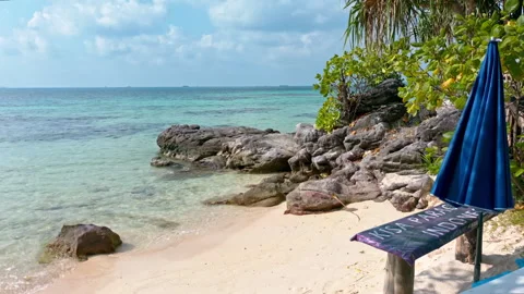 Relaxing beach view with parasol and chilling furniture in Karimunjawa Stockbeeldmateriaal 341037258