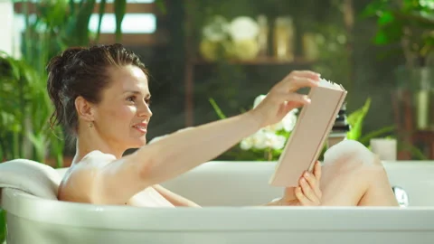 Relaxing Bubble Bath with a Good Book Stock Footage 320896774