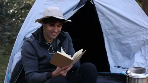 Relaxing Camping: Young Camper Reading in Forest Stock Footage 270414969