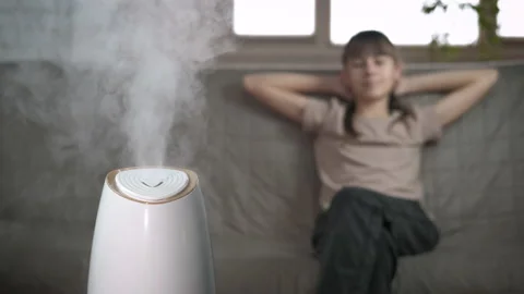 Relaxing child in aromatherapy diffuser steam. Stock Footage 226809843