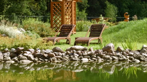 Relaxing on a deck chair by the river Stock-Footage 54218296