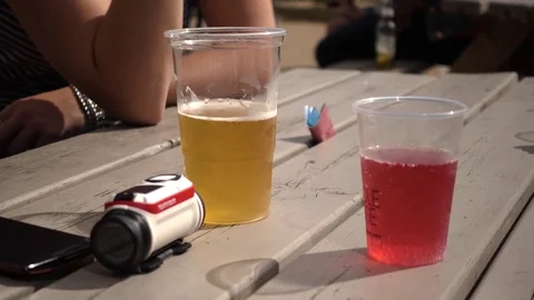 Relaxing drinking beer and cider outdoors Stock Footage 77074540