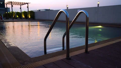 Relaxing evening at a rooftop pool with beautiful sunset view Stock Footage 280507524