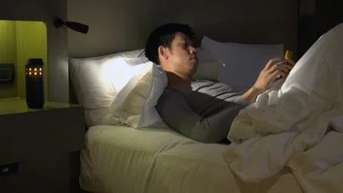 Relaxing Evening with Smartphone in Bed Stock Footage 315116775
