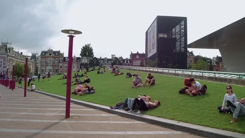 Relaxing on the greens of Museum Square - large meadows to lie on Stock Footage