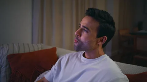 Relaxing guy watching comedy TV eating popcorn on home couch at night closeup. Stock Footage 278289866