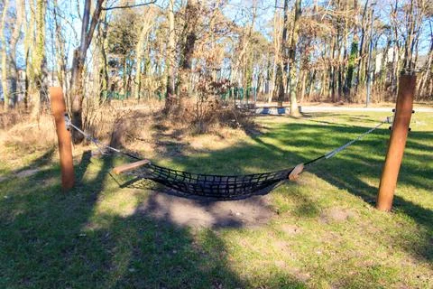 Relaxing hammock hanging between two trees in a lush forest Stock Photos