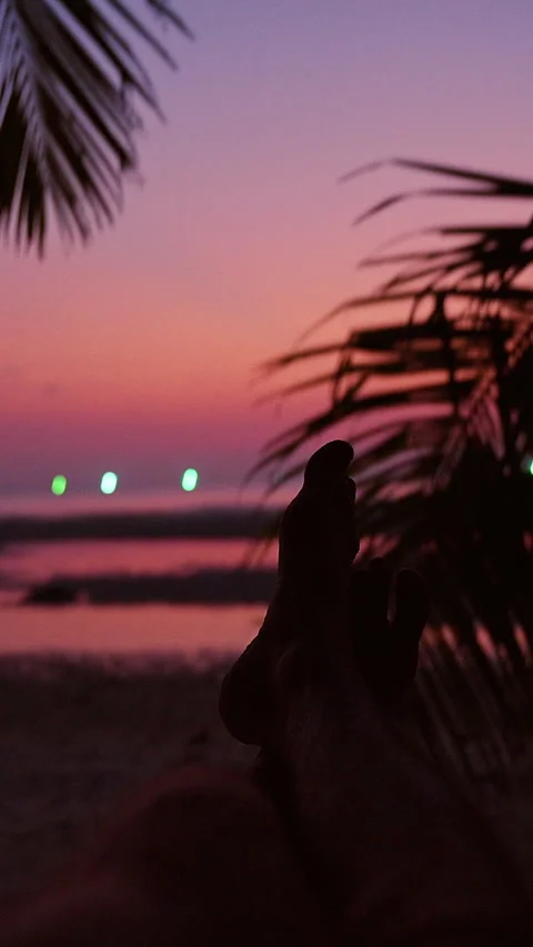 Relaxing in Hammock at Tropical Beach Sunset, point of view with feet silhouette Video stock 331416859