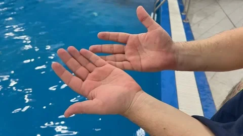 Relaxing Hands Over Summer Pool Stock Footage 305274528