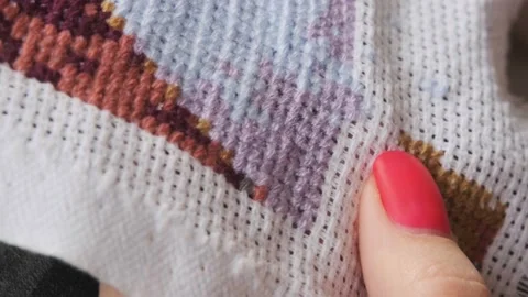 Relaxing hobby. Concentration. Cross-stitching close-up. The girl cross-stitches Stock Footage 196697048