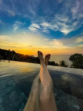 Relaxing in an Infinity Pool at Sunset with Ocean View Stock Photos