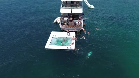Relaxing by an inflatable pool at sea during a trip to the islands Stock Footage 275328868