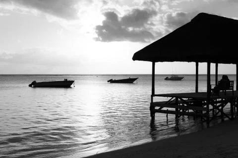 Relaxing on jetty at beach Stock Photos