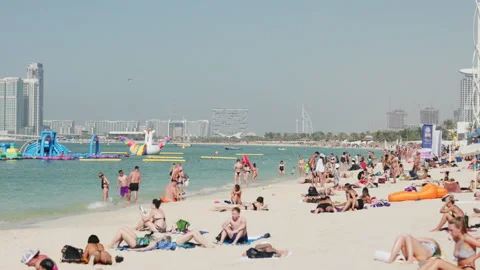 Relaxing at Marina Beach in Dubai Stock Footage 220107946