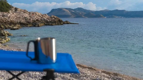 Relaxing with a mug on the seashore Stock Footage 321594839