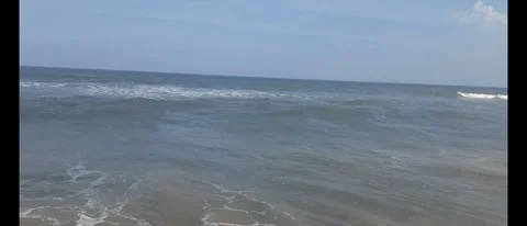 Relaxing Ocean Waves Crashing Gently Along a Serene Beach Shore Stock Footage 284782094