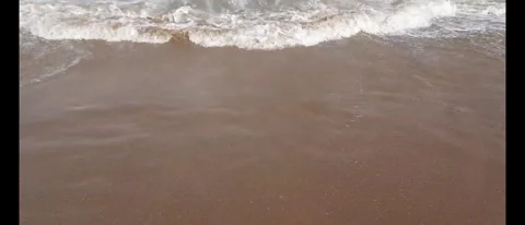 Relaxing Ocean Waves Crashing Gently Along a Serene Beach Shore Stock Footage 284782171