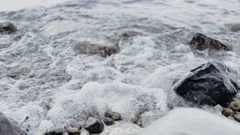 Relaxing Ocean Waves Crashing Over Smooth Rocks on a Beautiful Shoreline Stock Footage 337614687