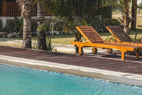 Relaxing Poolside with Two Comfortable Lounge Chairs. Poolside Serenity. Stock Photos