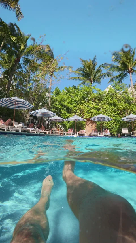 Relaxing POV of Legs Floating in Pool at Parrot Key Hotel and Villas Key West. Video stock 340543621