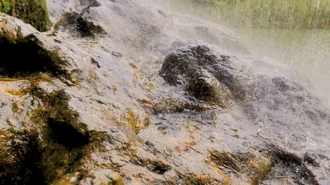 Relaxing rain of water waterfall falling on rock in slow motion Stock Footage 124389662
