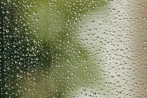 The relaxing raindrops is flowing down the window. Stock Photos