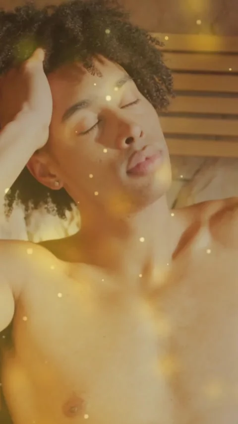 Relaxing in sauna, man surrounded by glowing particles Stock Footage 343824498