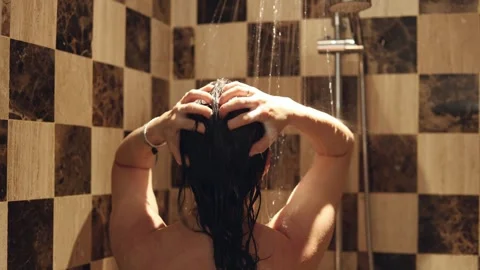 Relaxing shower experience in modern bathroom with natural stone tiles and Stock Footage 306410306