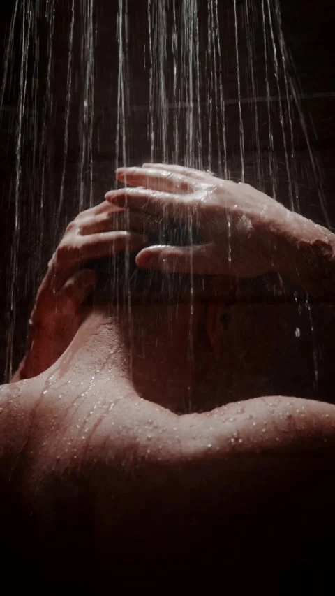 Relaxing shower routine featuring a person washing hair in a calming environment Stock Footage 312861266