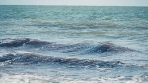 Relaxing slow motion view of turquoise waves crashing onto beach Stock Footage 119534309