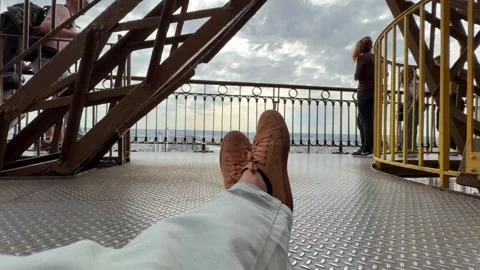 Relaxing with sneakers viewing Paris from Eiffel Tower Stock-Footage 334187868