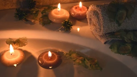 Relaxing spa background with candles floating in the bath water, some Stock Footage 100573749