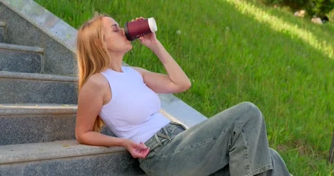 Relaxing on the Steps with a Cup of Coffee Stock Footage 306528734