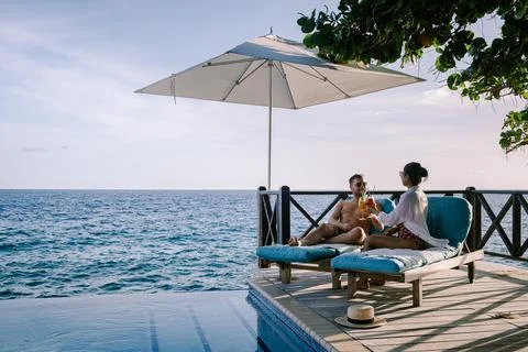 Relaxing summer beach , Sunbathing deck and private swimming pool with Palm Stock Photos