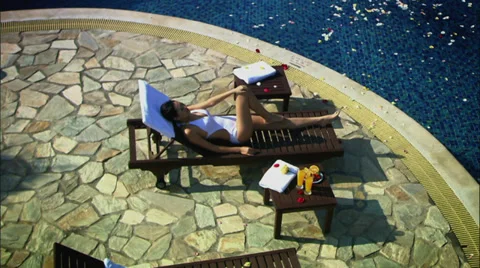 Relaxing at swimming pool Stock Footage 30477476