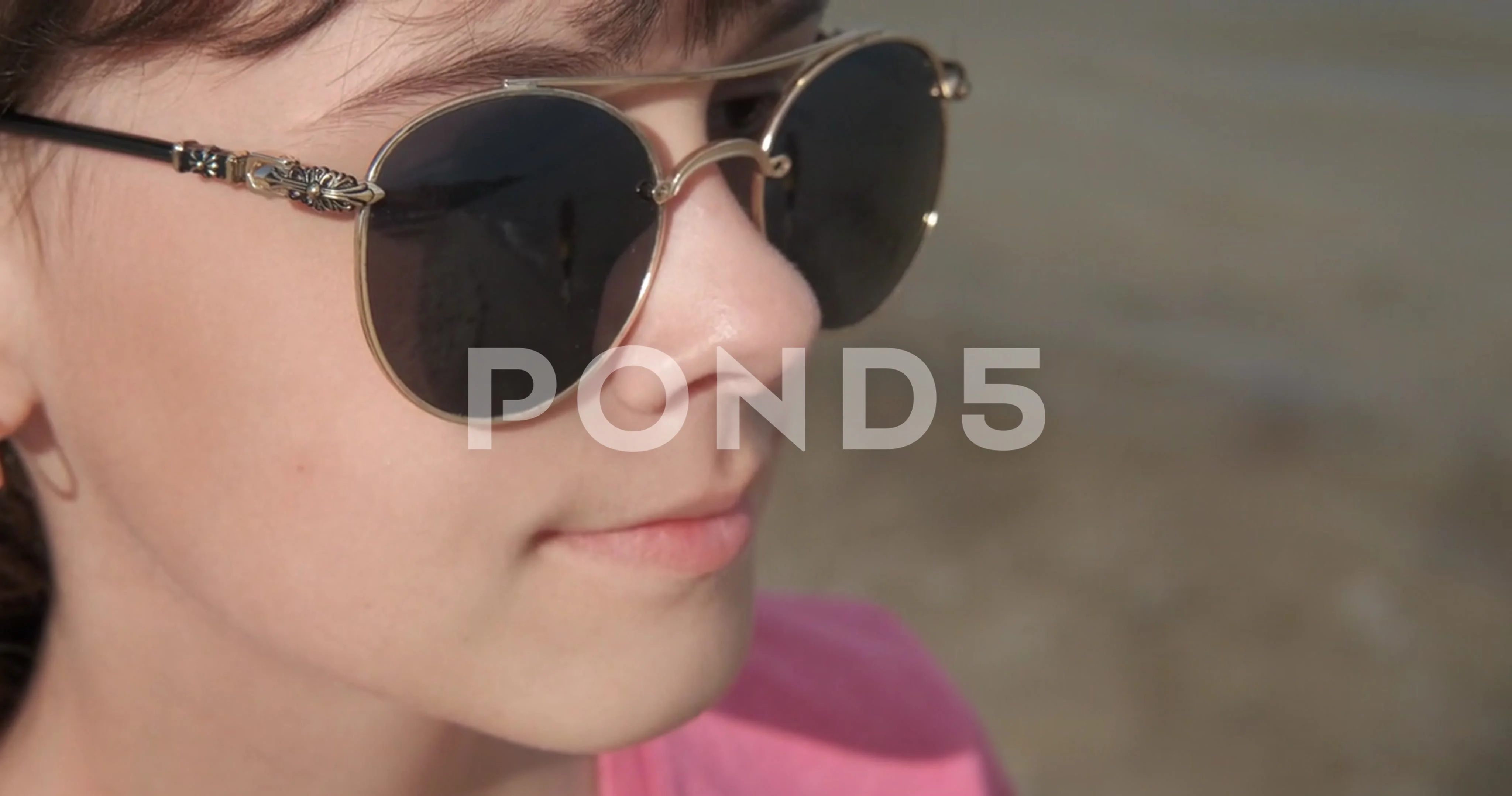 Relaxing teen in sunglasses on the beach, Stock Video