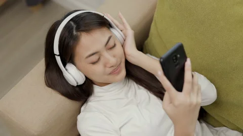 Relaxing time on sofa. Beautiful young asian woman lay down on sofa. Stock Footage 159850778