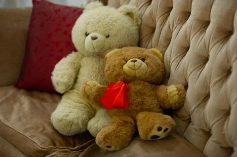 Relaxing time, two teddy bear friend sitting in the bed, vintage warm light f Stock Photos