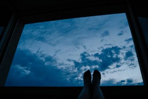Relaxing View of Cloudy Sky Through Window at Twilight Stock Photos
