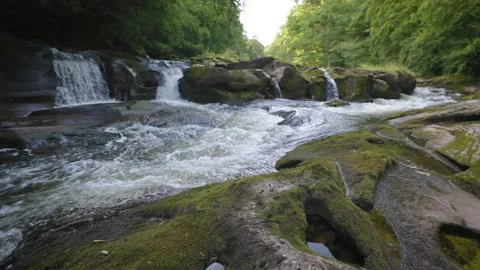 Relaxing water flow in a river with unique rocks Видео 157612828