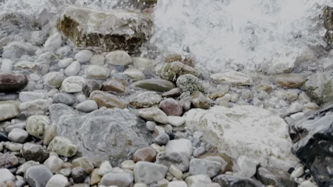 Relaxing Water Flowing Over Smooth Colorful Stones on the Beach Stock Footage 337612743