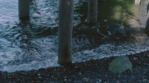 Relaxing Waves Gently Splashing Against the Shore and Dock in Peaceful Harbor Stock Footage 83152147