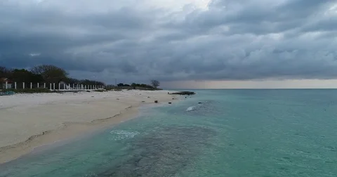 Relaxing waves lapping on tropical beach before thunderstorm Stock Footage 81686175