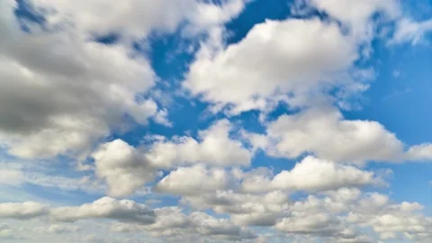 Relaxing White Clouds passing below blue sky in time lapse clip Stock Footage 131389635
