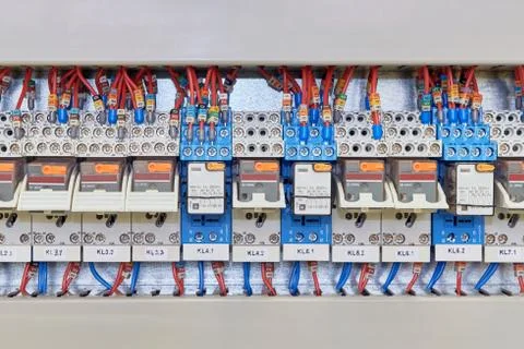 Relay is installed in series in the electrical control panel. Stock Photos