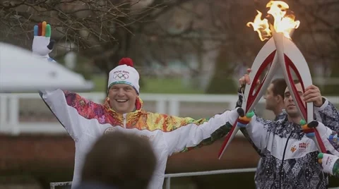 Relay race Olympic flame in Peterhof, Saint Petersburg. Torchbearer pass flame Stock Footage 62878053
